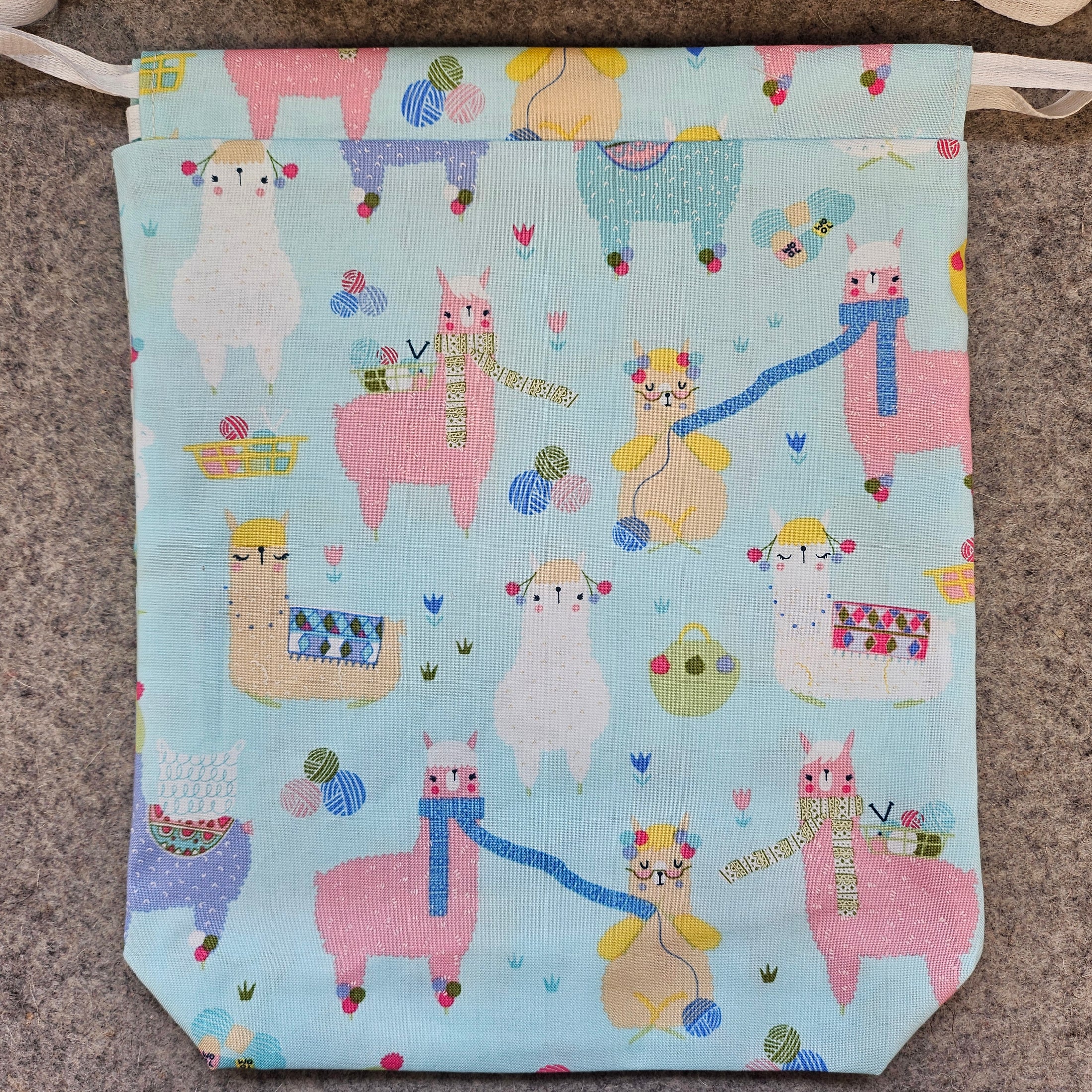 Children's bag with llama pattern on a textured surface