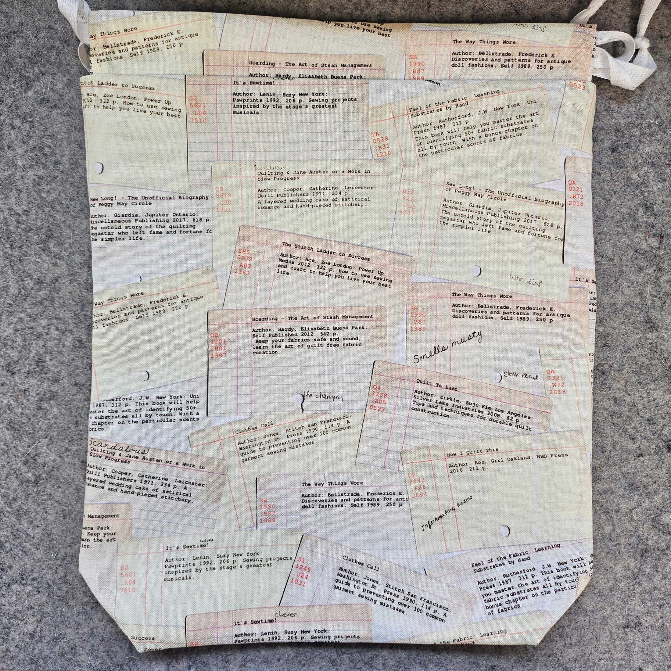 Fabric bag with printed text and forms on a gray surface