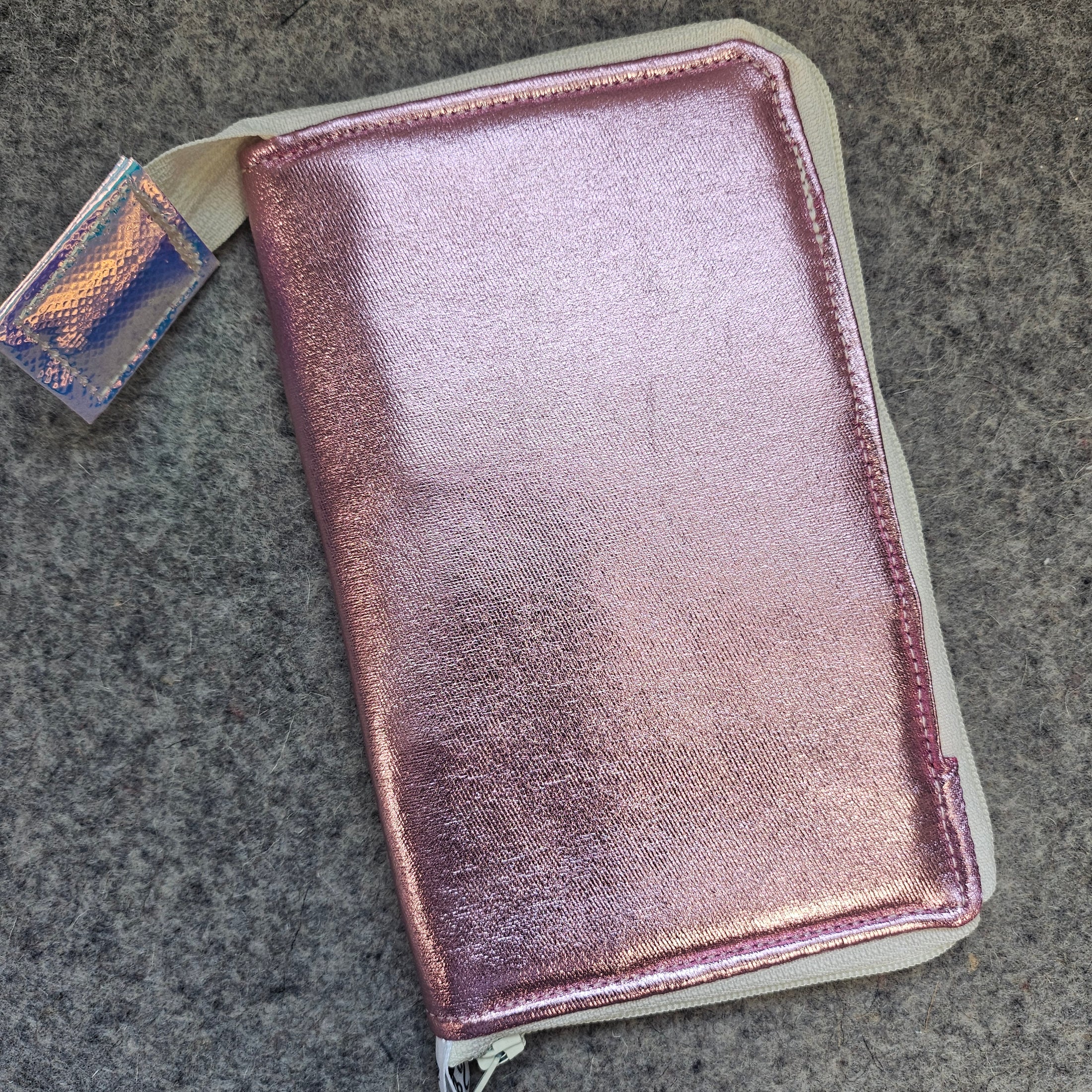 Pink glittery wallet on a gray surface