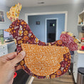 Load image into Gallery viewer, Hand holding a decorative item with floral patterns in a kitchen setting
