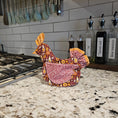 Load image into Gallery viewer, Decorative headscarf with floral patterns on a kitchen counter next to bottles of cooking wine, soy sauce, and oil.
