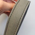 Load image into Gallery viewer, Close-up of a beige fabric strip held by a hand against a white background
