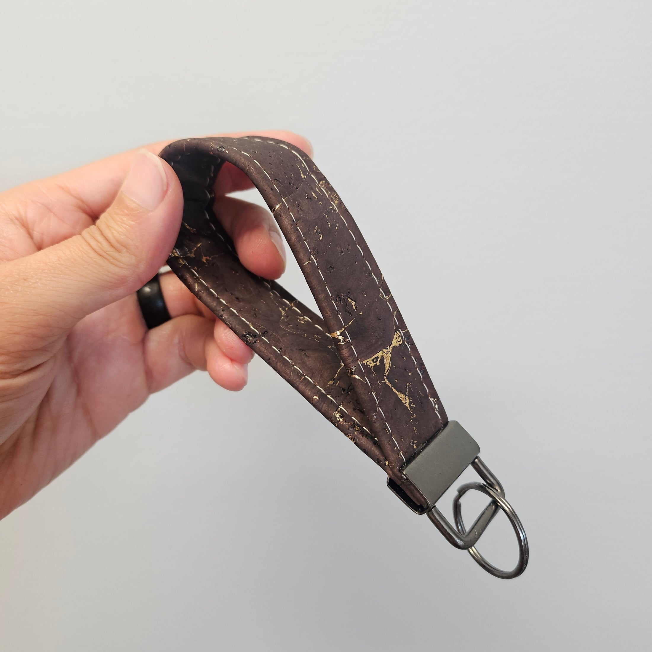 Fancy cork key fob with gold and brown.