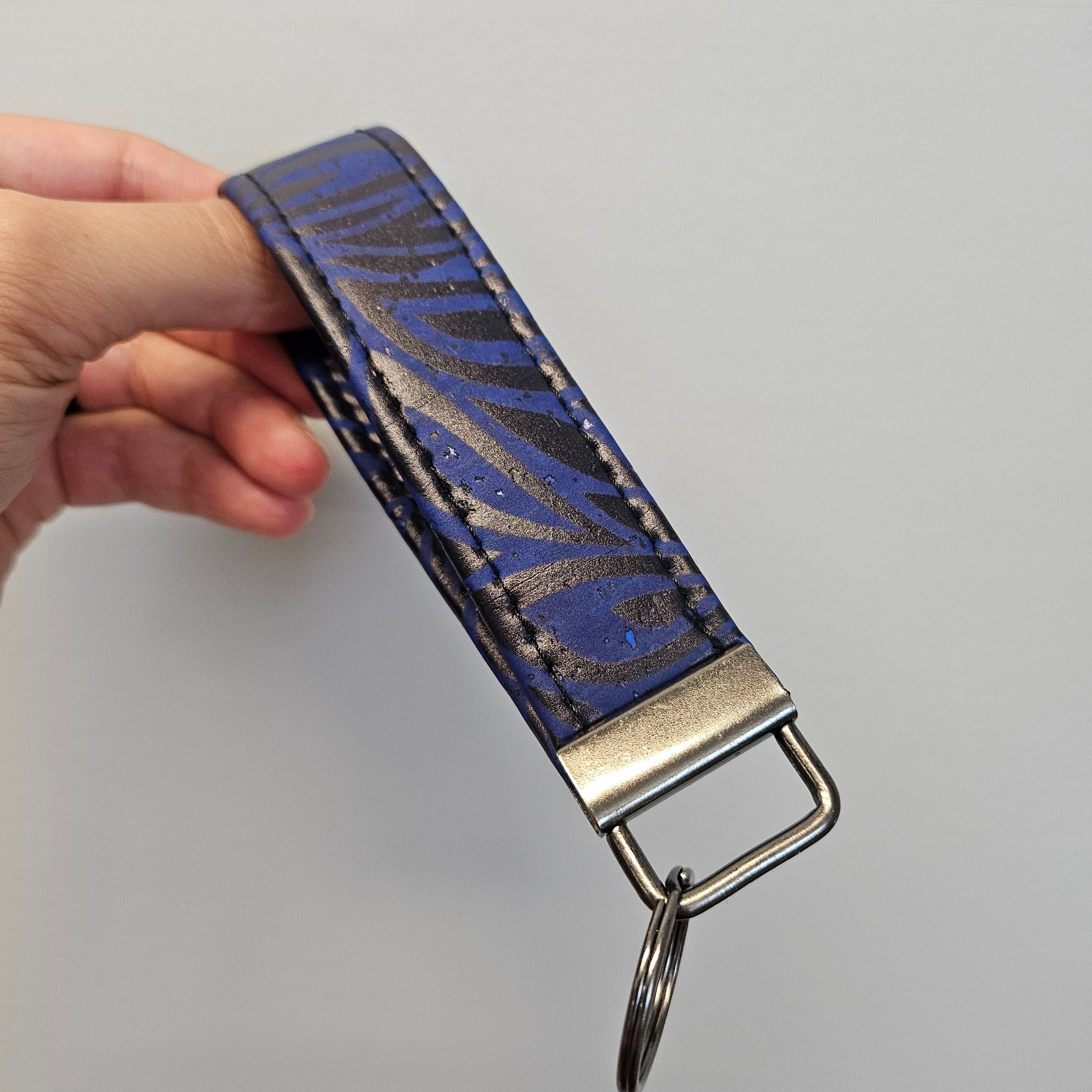 Blue and black cork key fob with metal hardware.
