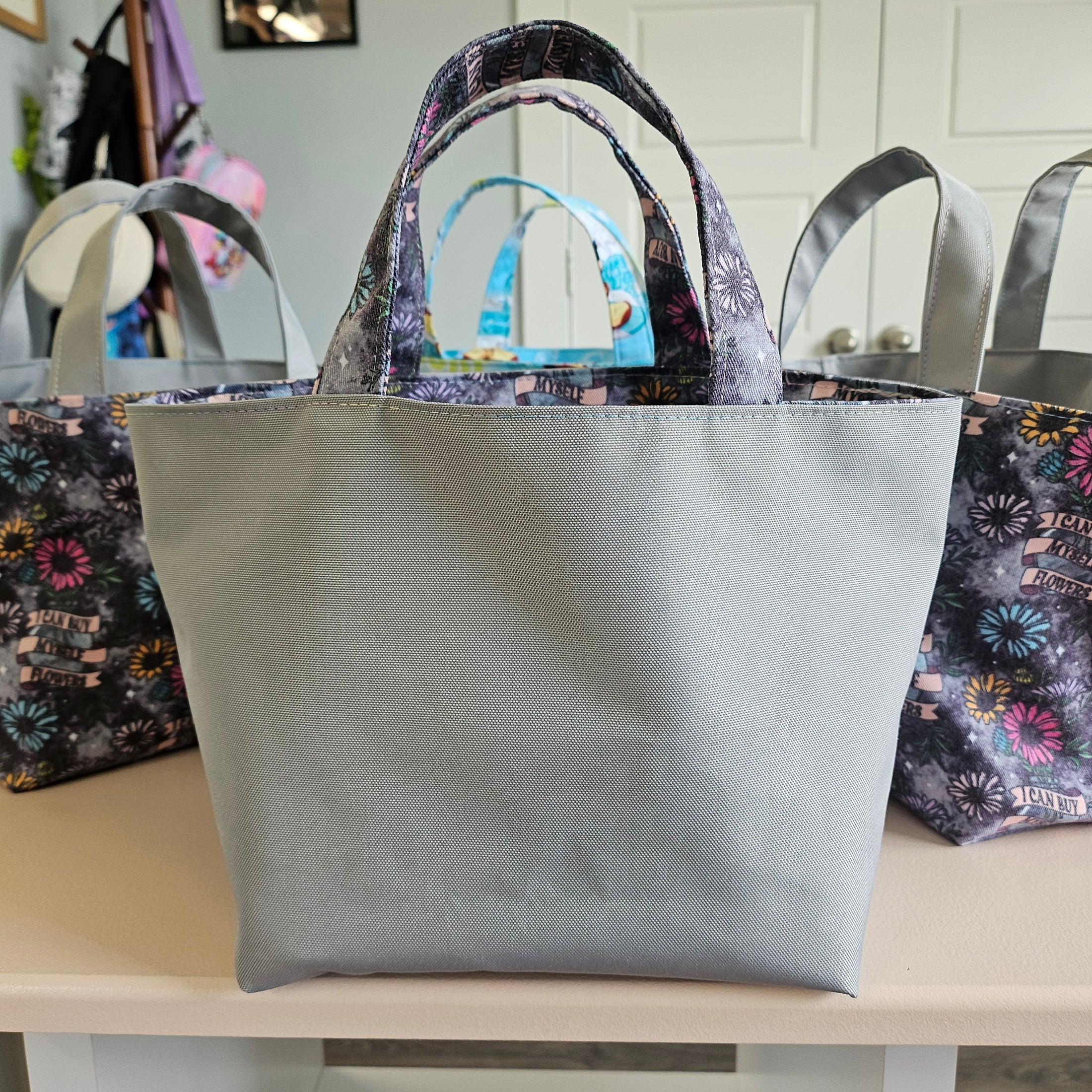 Grey water-resistant canvas mini tote bag exterior