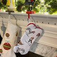 Load image into Gallery viewer, Bone shaped Christmas stocking for dogs hanging on a mantle.
