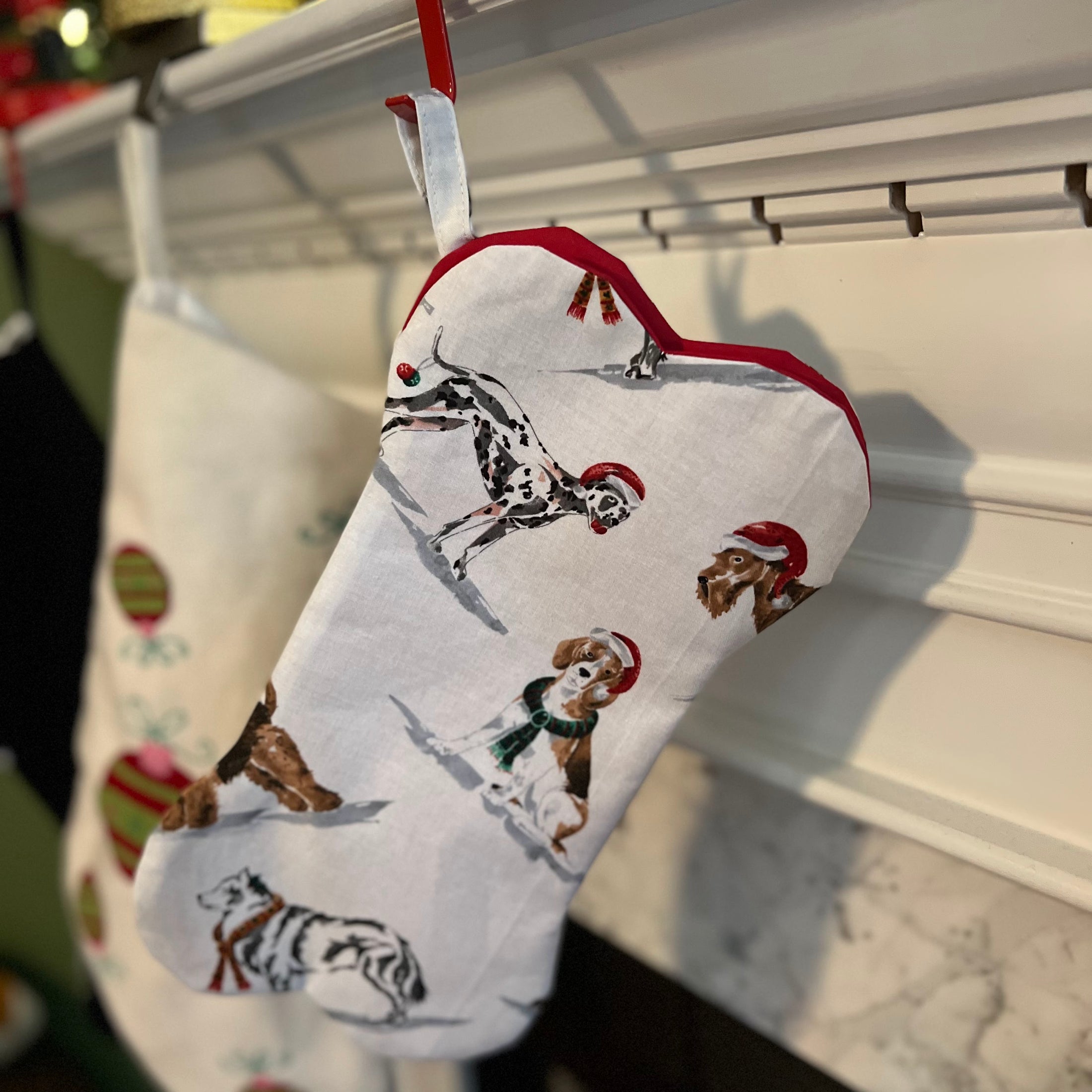 Dog holiday stocking showing dogs dressed up with Santa hats. 