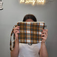 Load image into Gallery viewer, Orange and brown flannel clutch.
