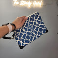 Load image into Gallery viewer, Blue and cream wristlet clutch with black vegan leather accents. 
