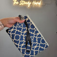 Load image into Gallery viewer, Blue and cream wristlet pouch with black wristlet strap.
