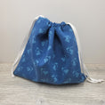 Load image into Gallery viewer, Dark blue drawstring cross stitch bag with white ribbon.
