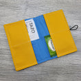 Load image into Gallery viewer, Yellow and blue interior of tea bag wallet. 

