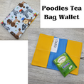 Load image into Gallery viewer, Poodles tea bag wallet with blue and yellow interior.
