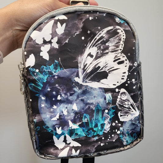 Celestial crystal butterfly vinyl sling bag with adjustable strap.