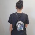Load image into Gallery viewer, Person wearing the celestial crystal butterfly bag on the bag.
