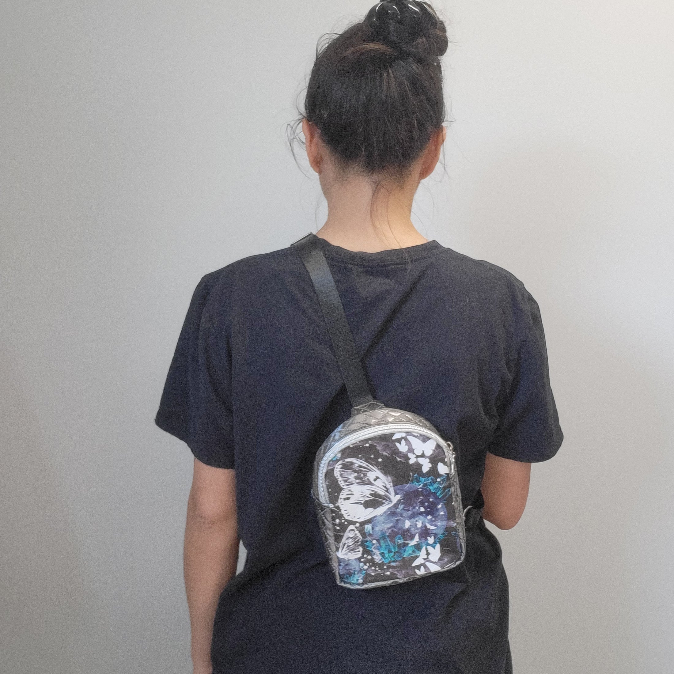 Person wearing the celestial crystal butterfly bag on the bag.