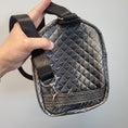 Load image into Gallery viewer, Quilted silver back of celestial crystal butterfly sling bag with repositionable strap.
