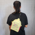 Load image into Gallery viewer, Dear human behind me sling bag being worn by a person with a black shirt.
