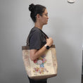 Load image into Gallery viewer, Vintage flower seed tote bag worn on the shoulder.
