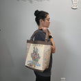 Load image into Gallery viewer, Vintage flower seed tote bag over the shoulder.
