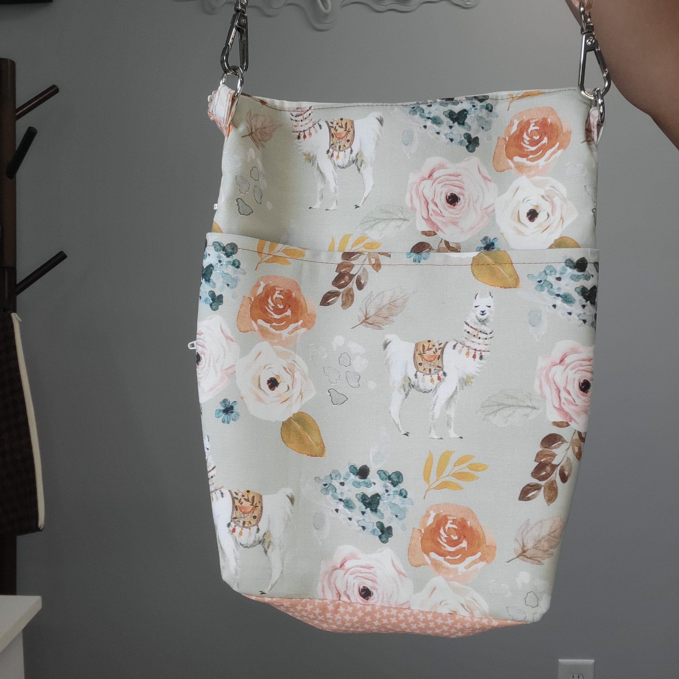 Floral llama convertible crossbody purse with large slip pocket on the back. 