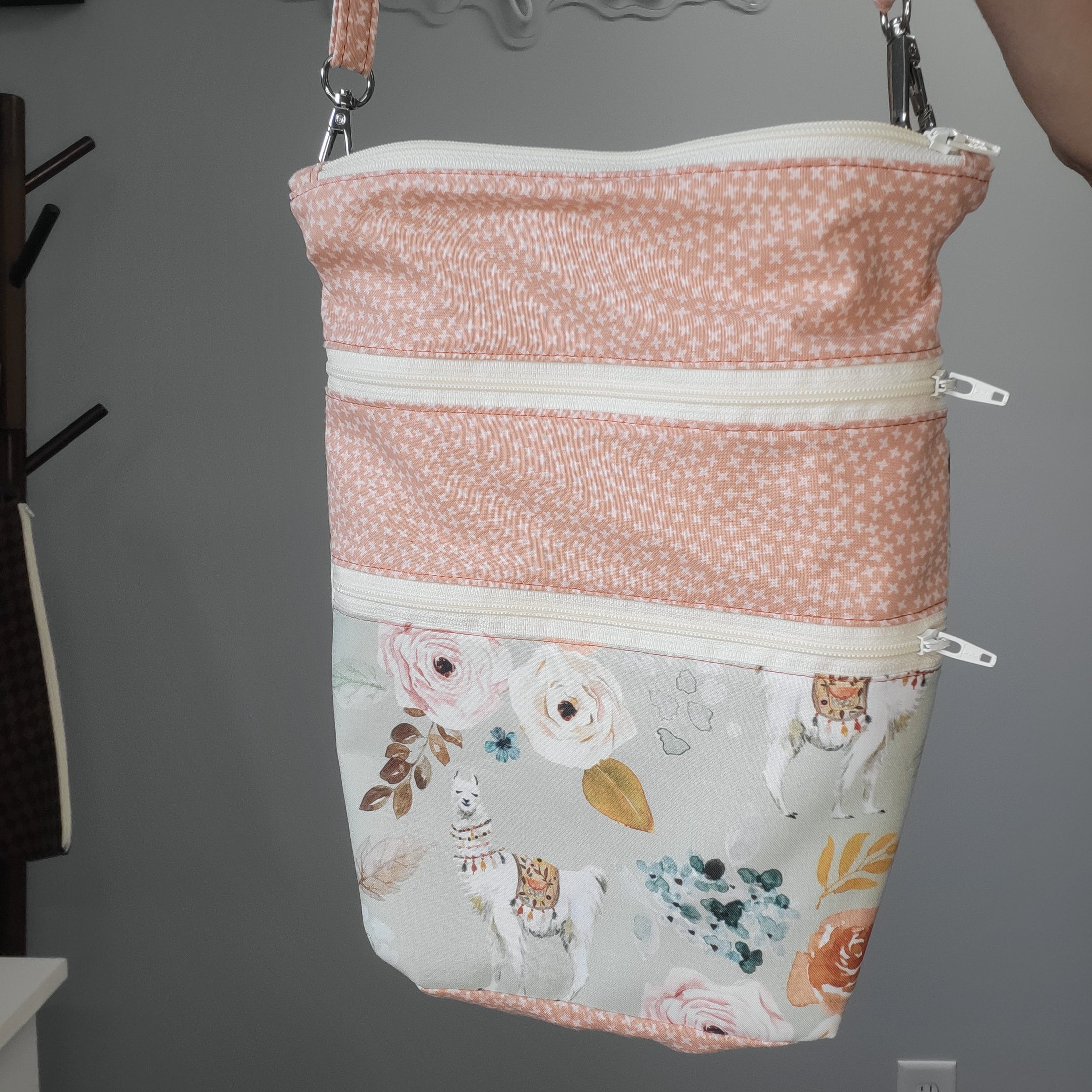 Floral llama convertible crossbody purse with removable strap.