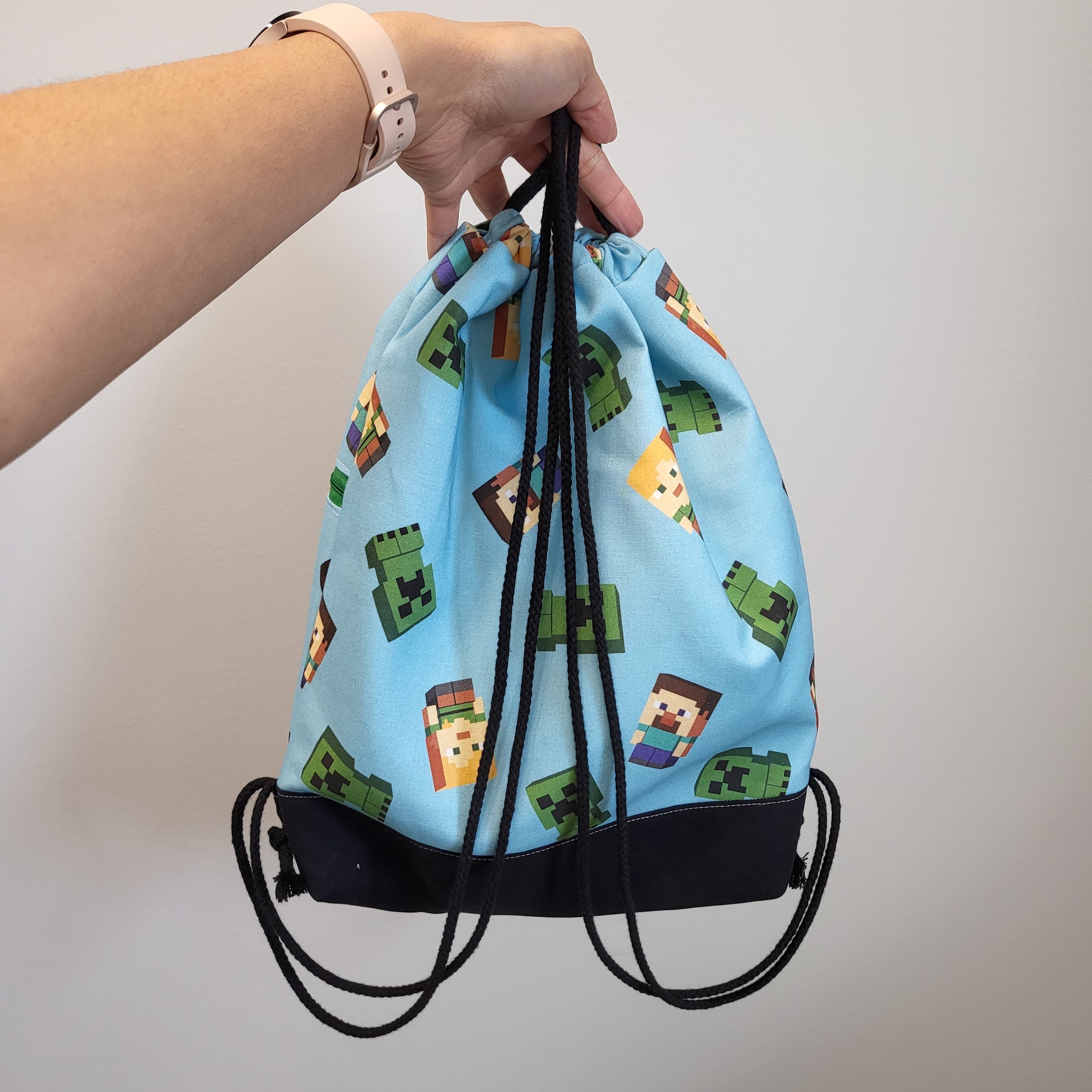 Back of the Minecraft drawstring backpack featuring black drawstring and black bottom. 