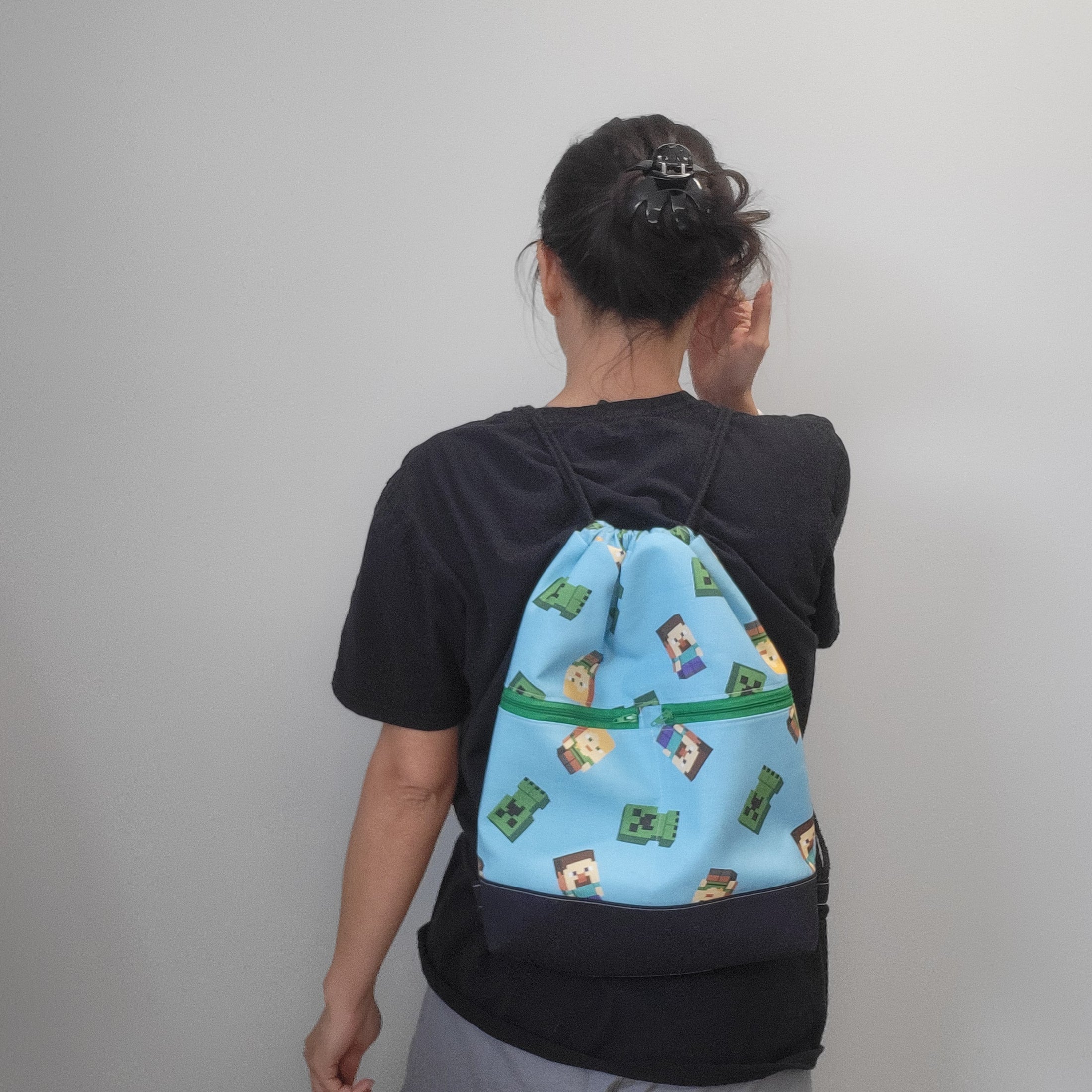 Person wearing the Minecraft drawstring backpack as a backpack. 