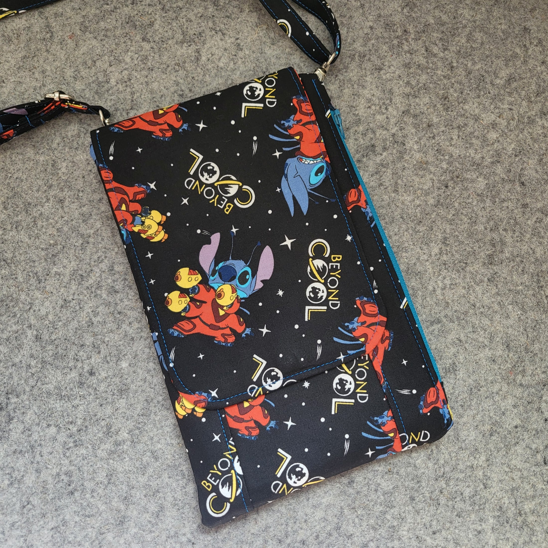 Beyond cool stitch in space cell phone purse with flap.