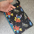 Load image into Gallery viewer, Beyond cool stitch in space cell phone bag with exterior slip pocket.
