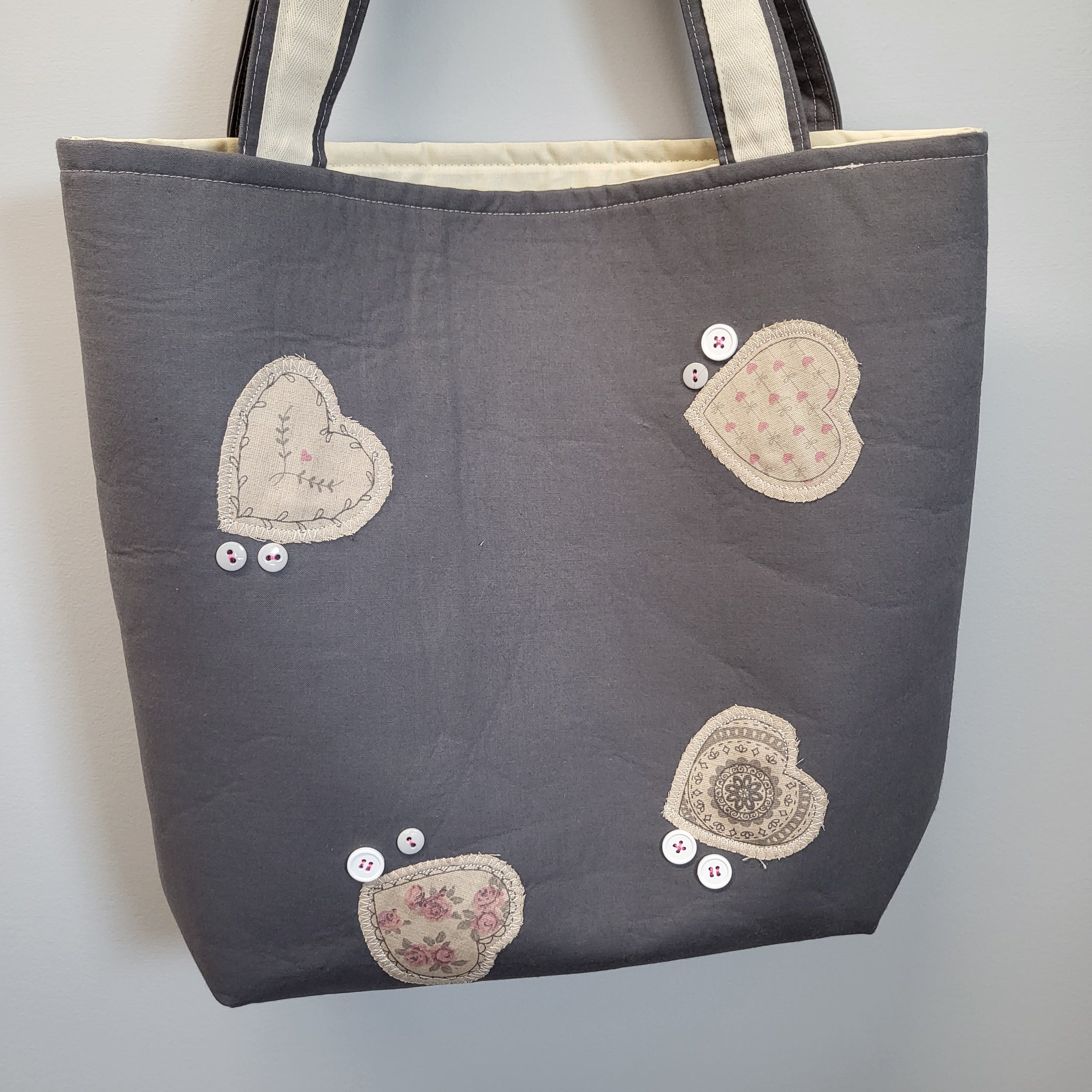 Quilted heart totes with appliqued hearts and handsewn buttons. 