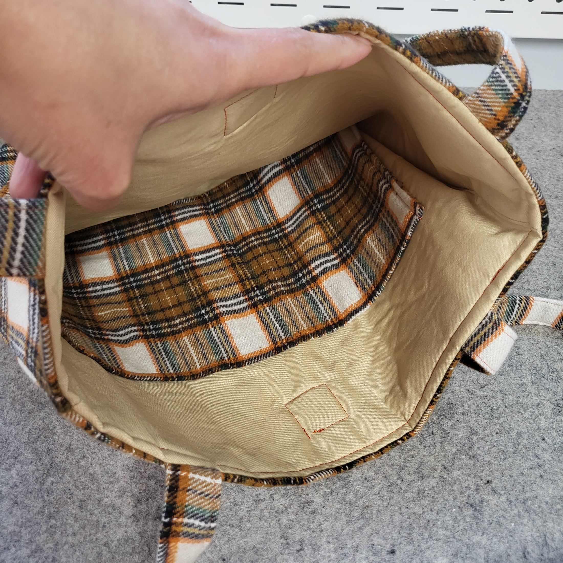Light brown interior of the plaid flannel tote bag.