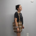 Load image into Gallery viewer, Person wearing the soft flannel tote bag on the shoulder. 
