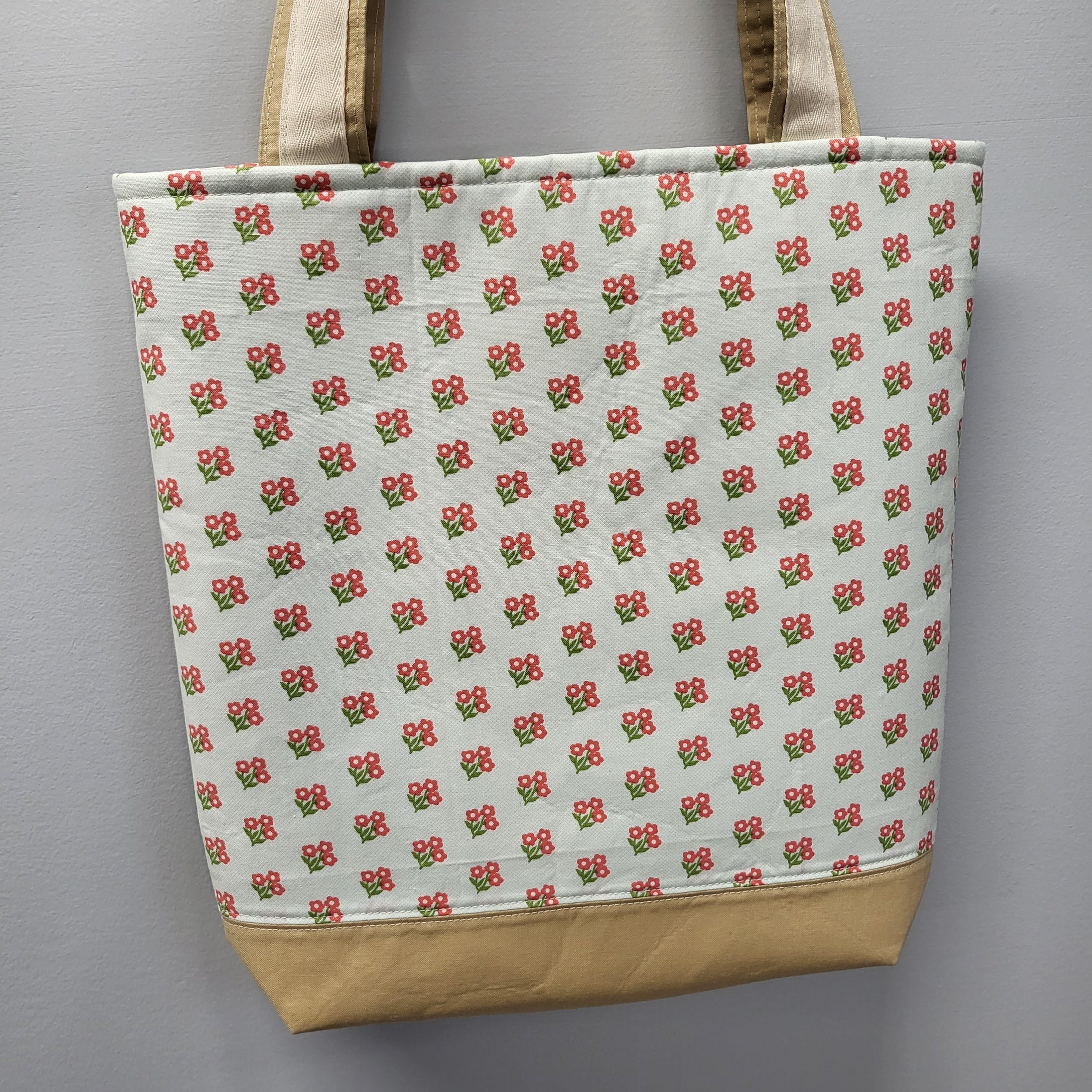 Back of the bluebirds tote bag with small pink and green flowers. 