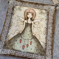 Load image into Gallery viewer, Close up view of the front of the heart fairy purse with the fairy surrounded by a lace white frame. 
