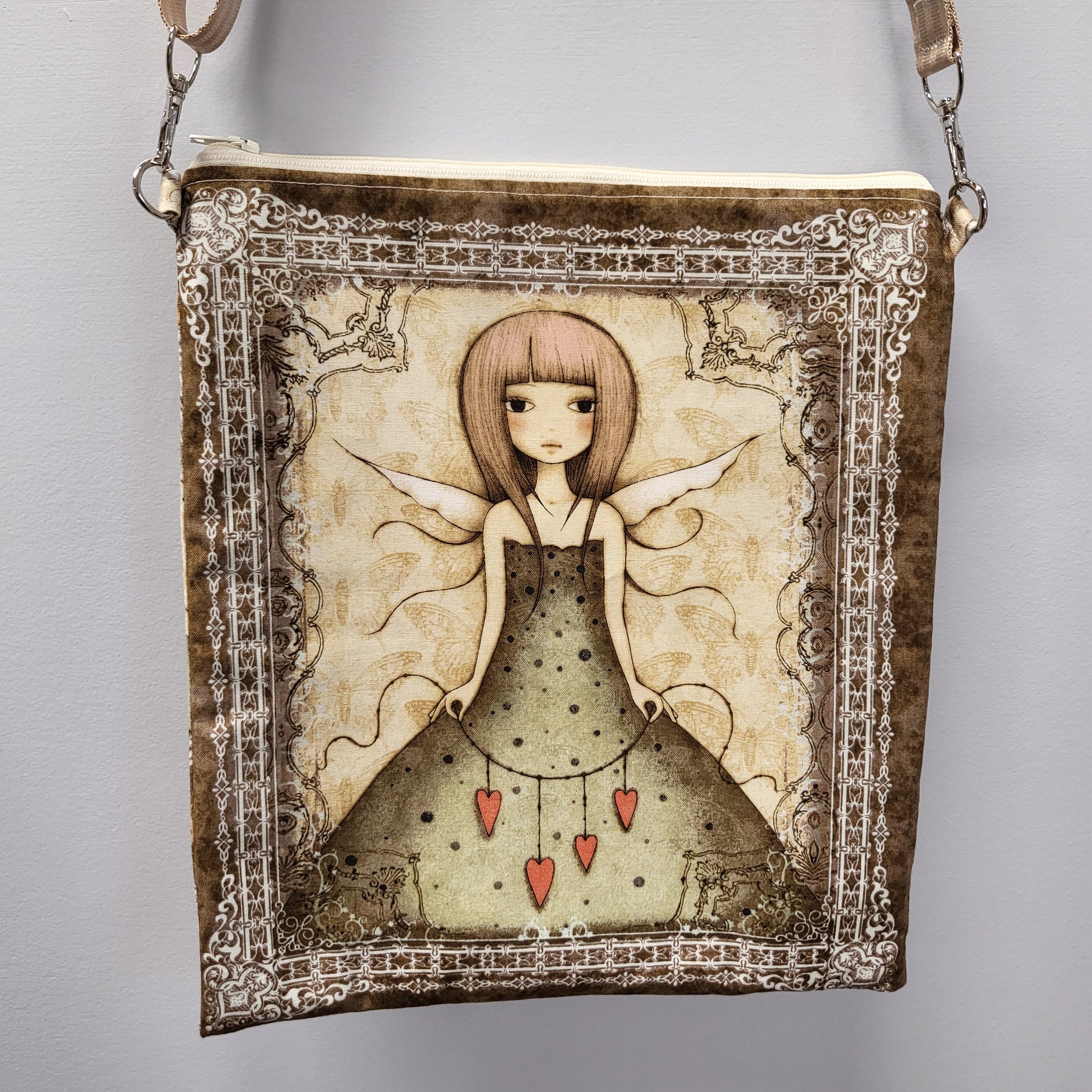 Front of the heart fairy purse with a fairy holding a string of hearts. 