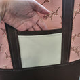 Load image into Gallery viewer, Brown and cream exterior slip pocket on the cherry blossom tote bag. 
