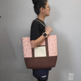 Load image into Gallery viewer, Person wearing the cherry blossom tote bag on their shoulder. 
