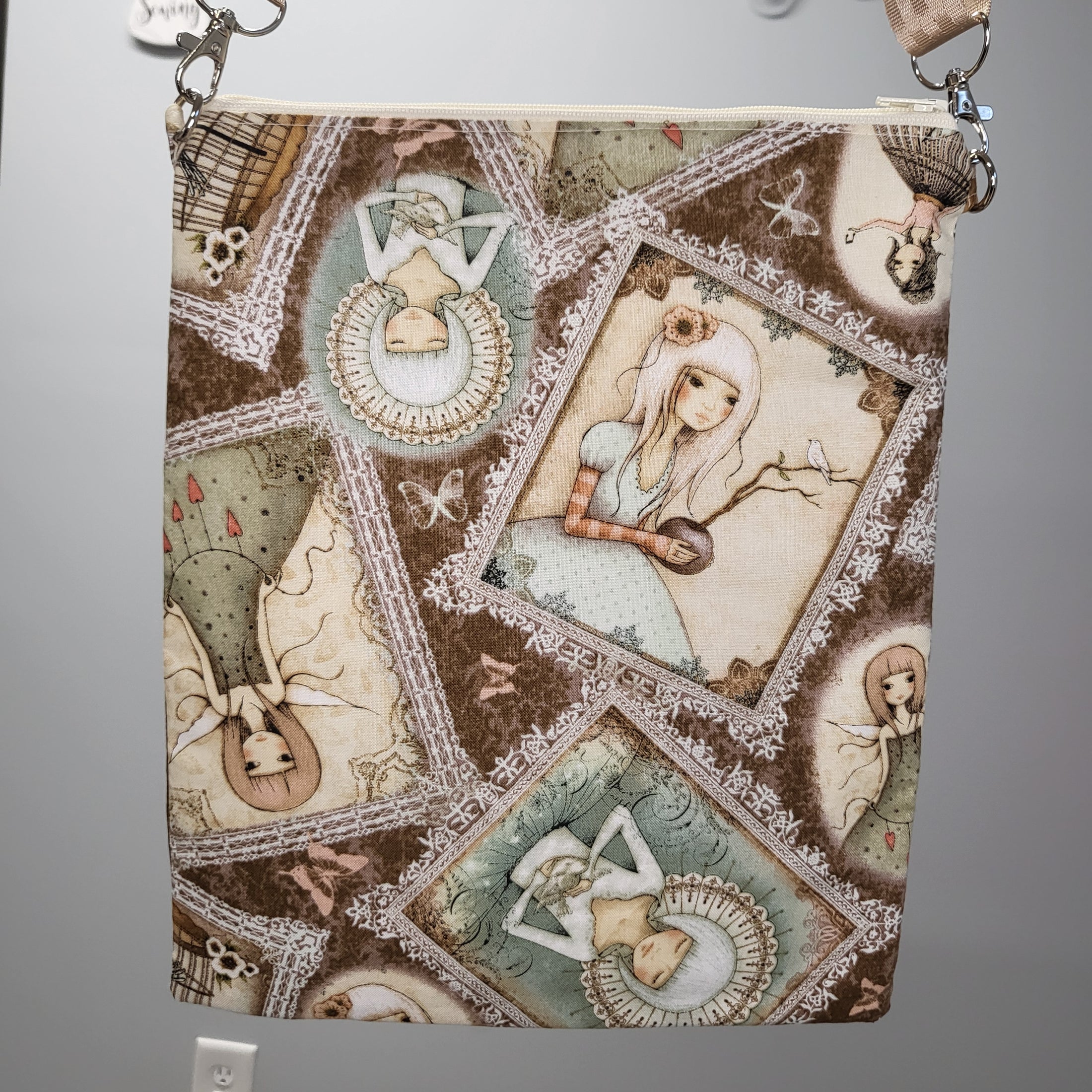 Back of the serenity and calm white dove purse showing frames of different ladies and fairies. 