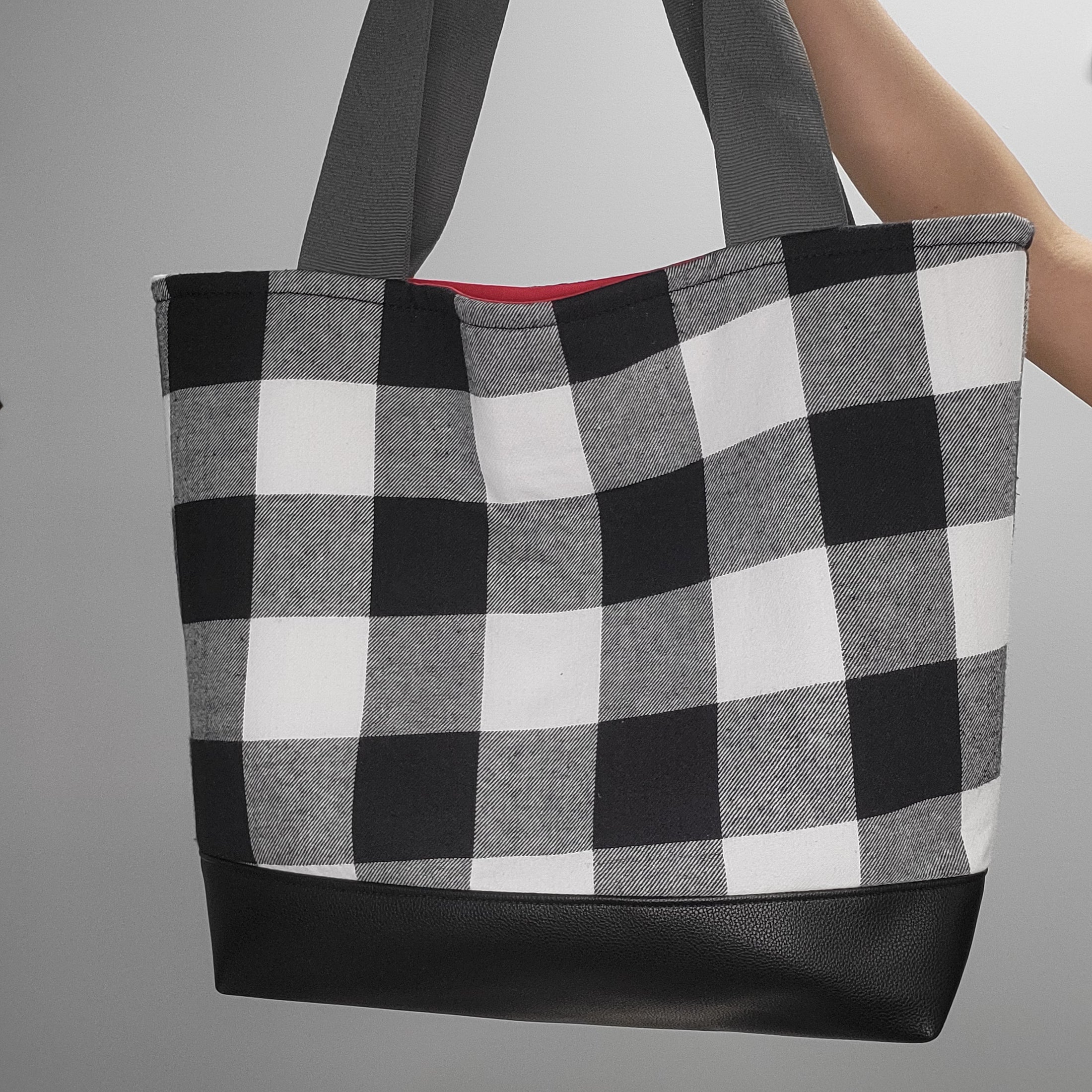 Black and white flannel tote bag with vegan leather black bottom. 