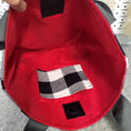 Load image into Gallery viewer, Black and white flannel tote with red interior.
