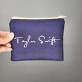 Load image into Gallery viewer, Back of the Swiftie zipper pouch showing Taylor Swift's signature in white on a dark blue background. 
