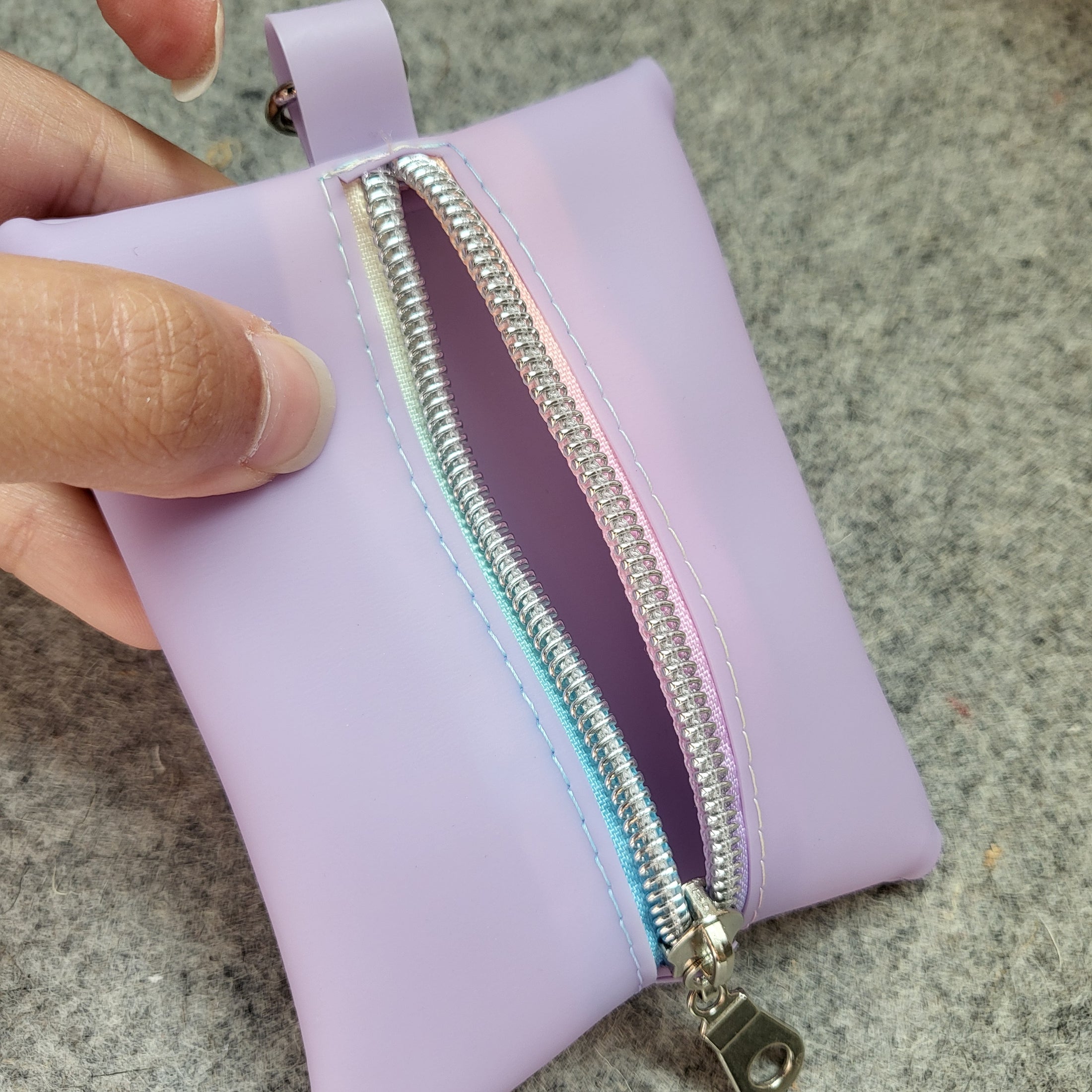 Light purple mini zipper pouch with rainbow zipper tape included with the Mario Kart inspired bag. 