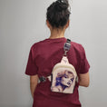 Load image into Gallery viewer, Person wearing the Swiftie Sling bag on their back.
