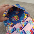 Load image into Gallery viewer, Exterior slip pocket on the hug life care bear purse. 
