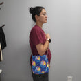 Load image into Gallery viewer, Person wearing the hug life care bear bag as a crossbody.
