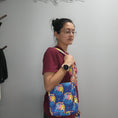 Load image into Gallery viewer, Person wearing the hug life care bear bag on their shoulder. 
