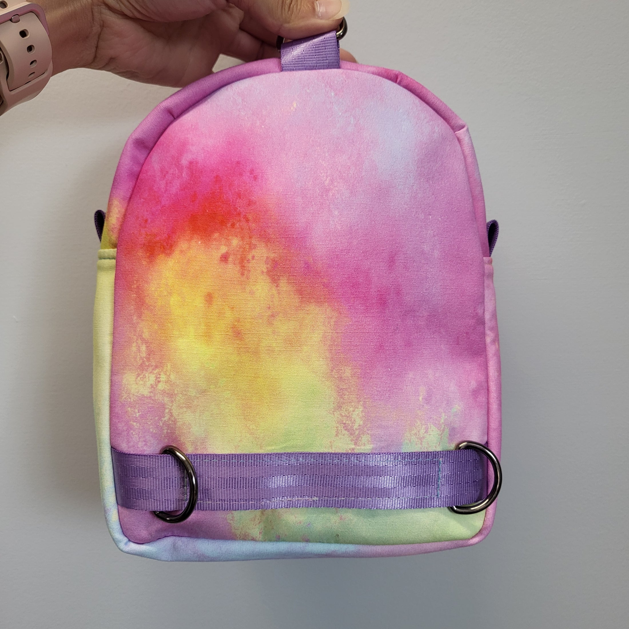 Back of the Mario Kart inspired bag featuring watercolor rainbow fabric and light purple polyester webbing.