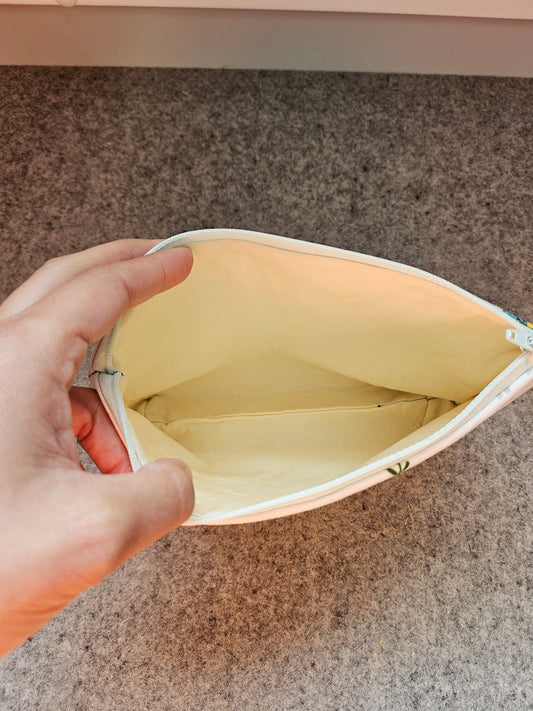 Pale yellow interior of the Porcupine Flowers zipper storage pouch.