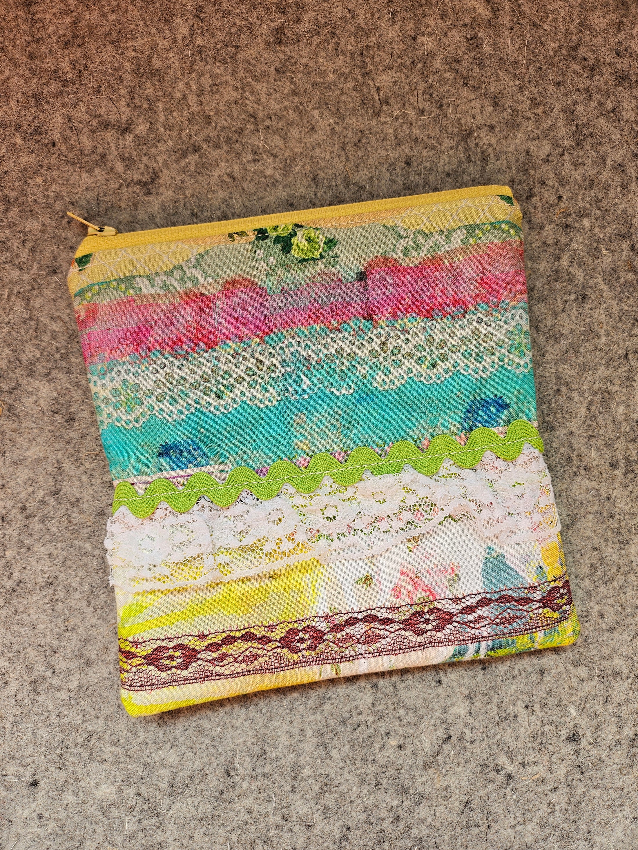 Watercolor lace zipper pouch embellished with lace and rick rack. 